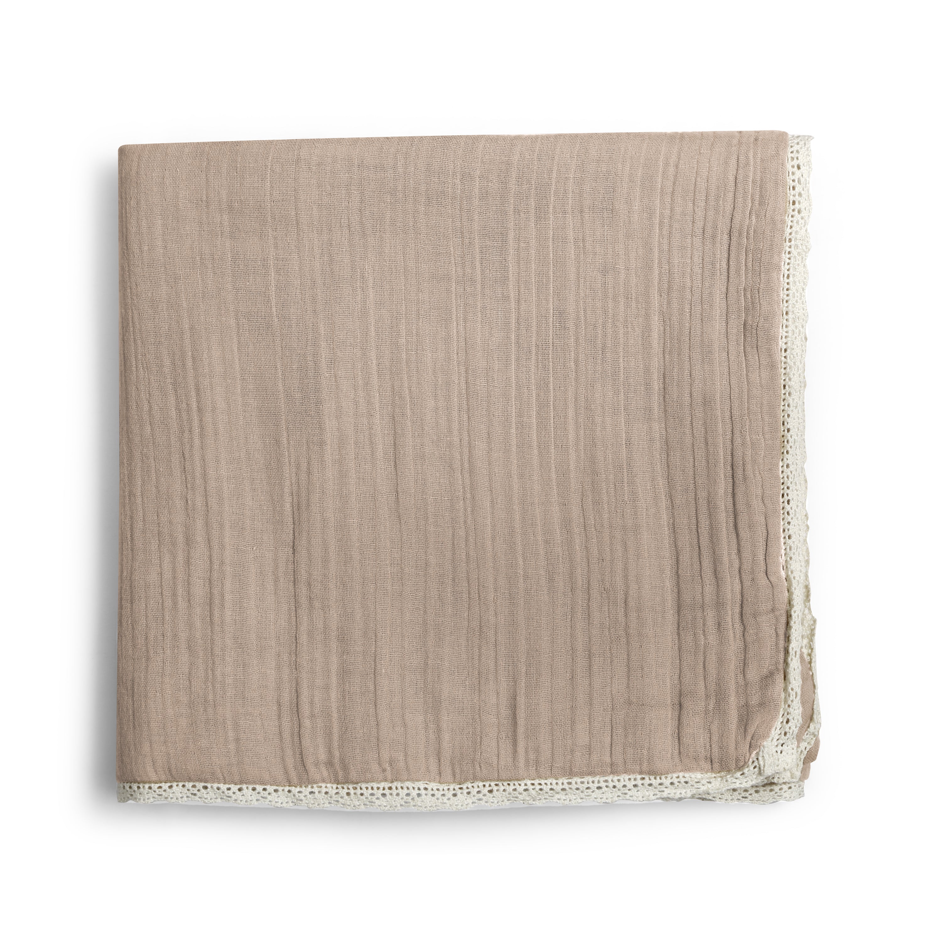 A taupe organic cotton muslin blanket with natural lace edges, neatly folded and placed on a white background. the fabric has a subtle striped texture by Makemake Organics.