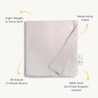 A light grey, crinkled Organic Cotton Muslin Blanket - Blush Oat + Ivory Lace displayed flat with annotations highlighting its features: "light weight & ultra soft," "generously sized," "50 gauze," and "100% certified organic cotton." (Brand Name: Makemake Organics)
