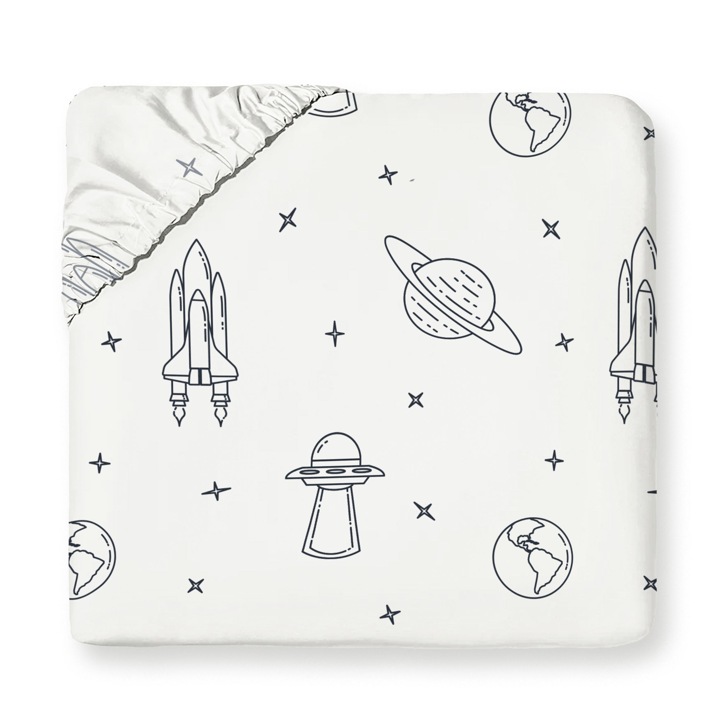 A white baby blanket with a Celestial-themed pattern featuring rockets, planets, stars, and ufos, partially folded to show a silver satin edge by Makemake Organics.