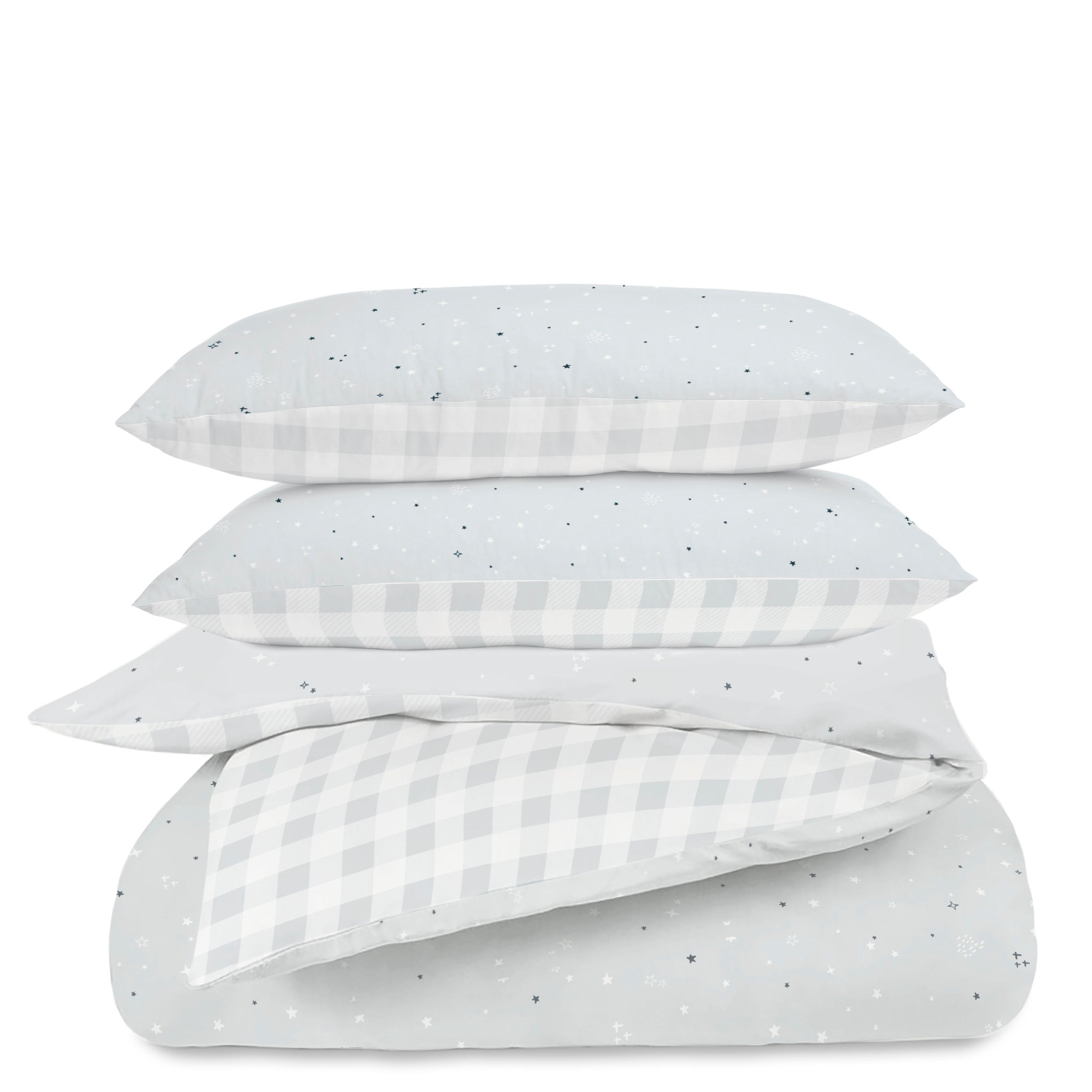 Four stacked pillows with different designs including polka dots, stars, and checkered patterns in shades of gray and white on a white background.