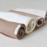 Three Organic Cotton Muslin Burp Cloths in shades of white, beige, and brown, labeled "Makemake Organics," displayed on a neutral background.