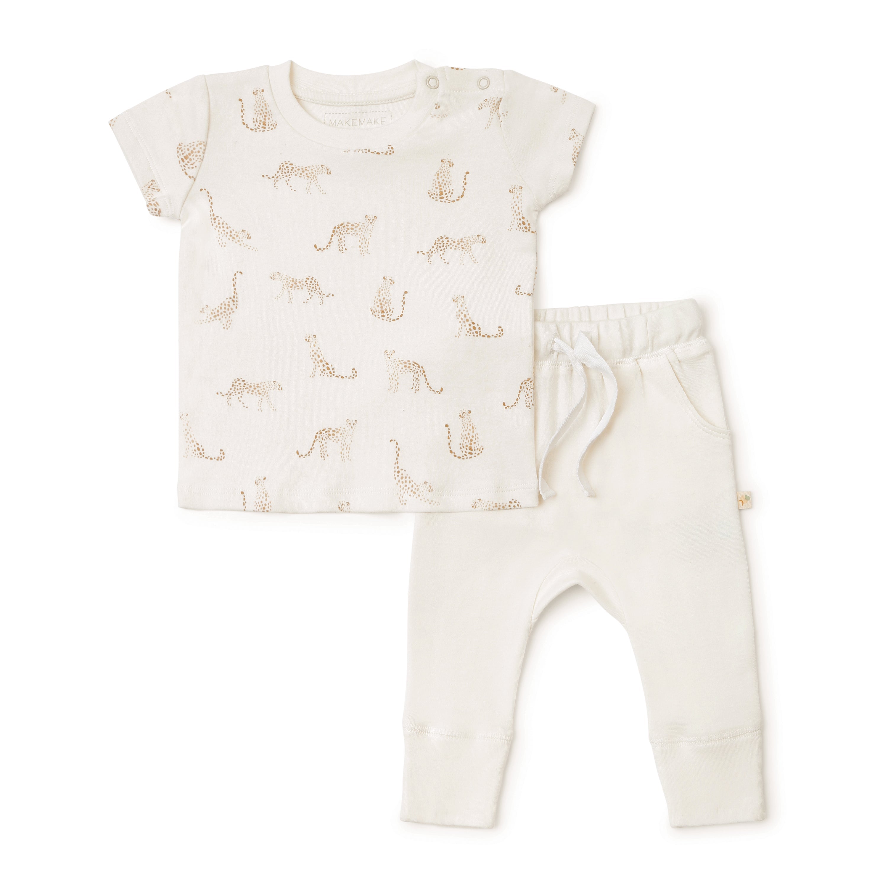 A baby outfit from Organic Kids comprising an Organic Tee & Pants Set - Wildcat Print, featuring a white short-sleeved shirt and matching pants adorned with a pattern of golden giraffes. The shirt features two shoulder buttons.