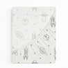 A Celestial Crib Fitted Sheet with Pillowcase by Makemake Organics folded neatly, featuring a pattern with planets, rockets, and spaceships in a monochrome color scheme on a white background.