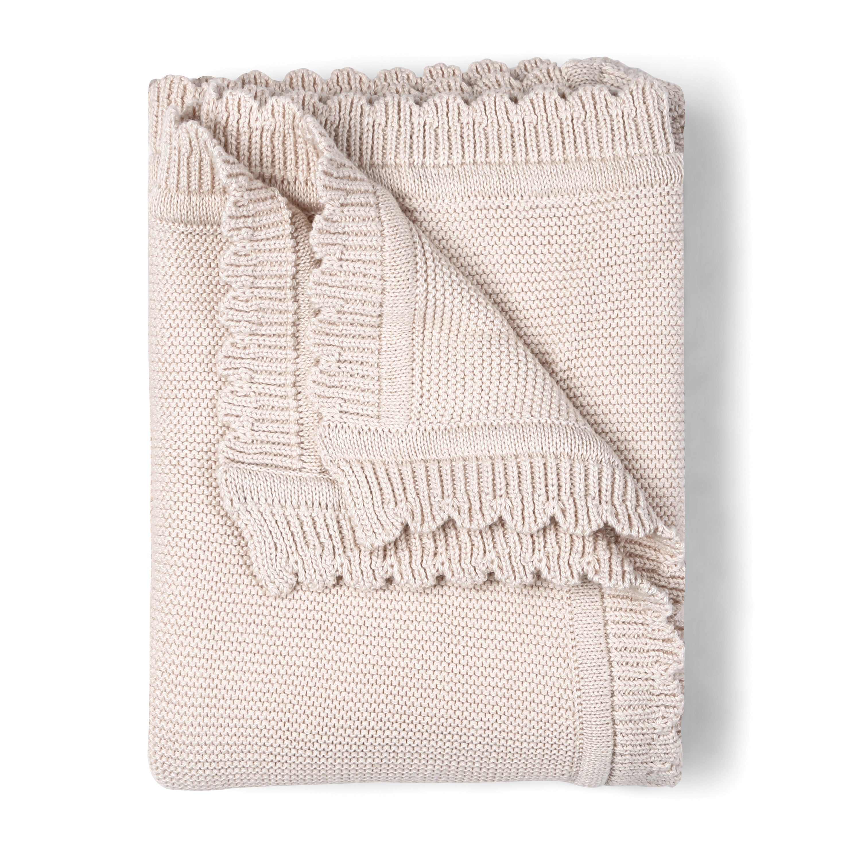 A neatly folded Organic Cotton Scalloped Baby Blanket in Nora Shell, from Makemake Organics, with a textured pattern and fringed edges, isolated on a white background.