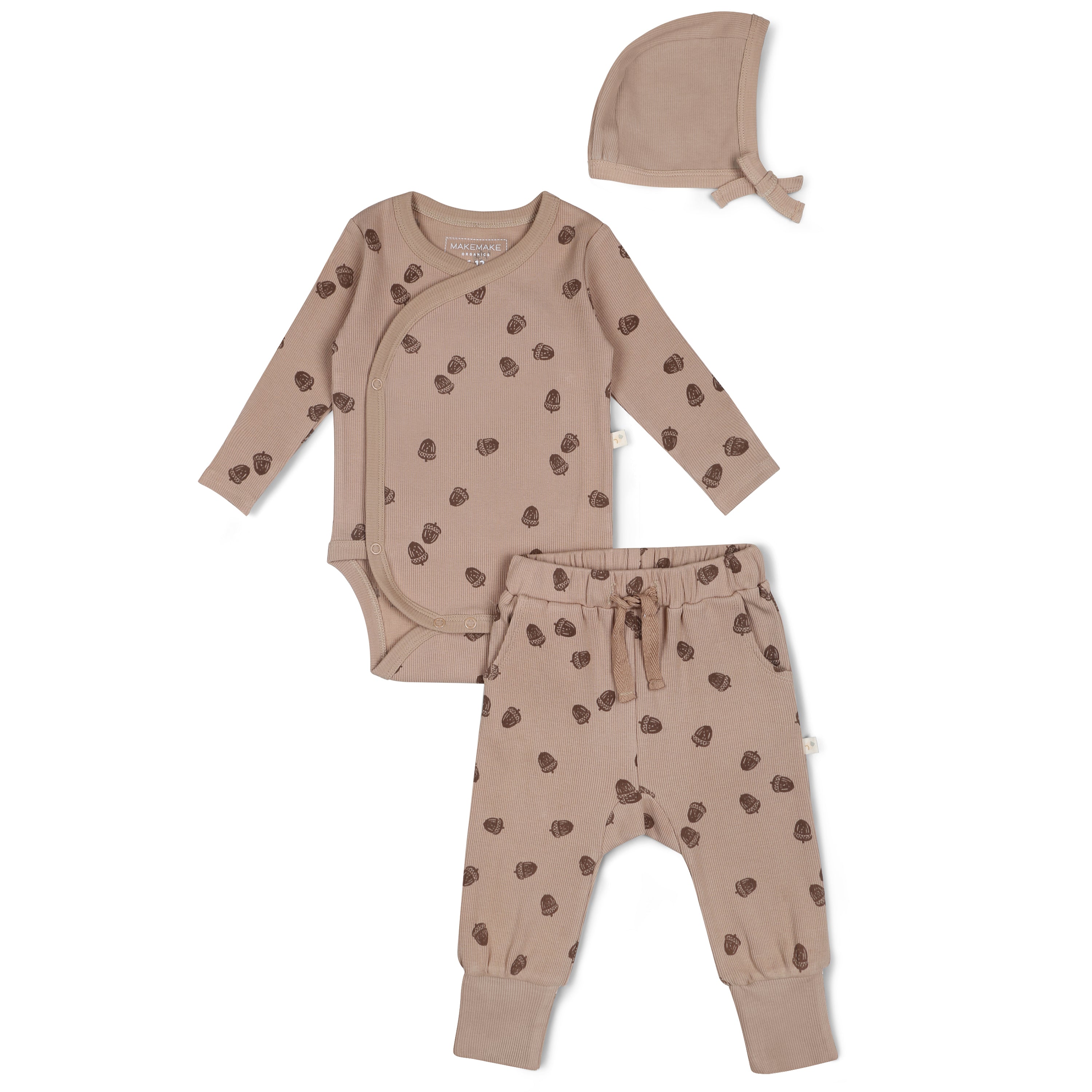 A beige baby outfit set with brown polka dots, including a long-sleeve onesie, pants with a drawstring, and a matching bonnet.