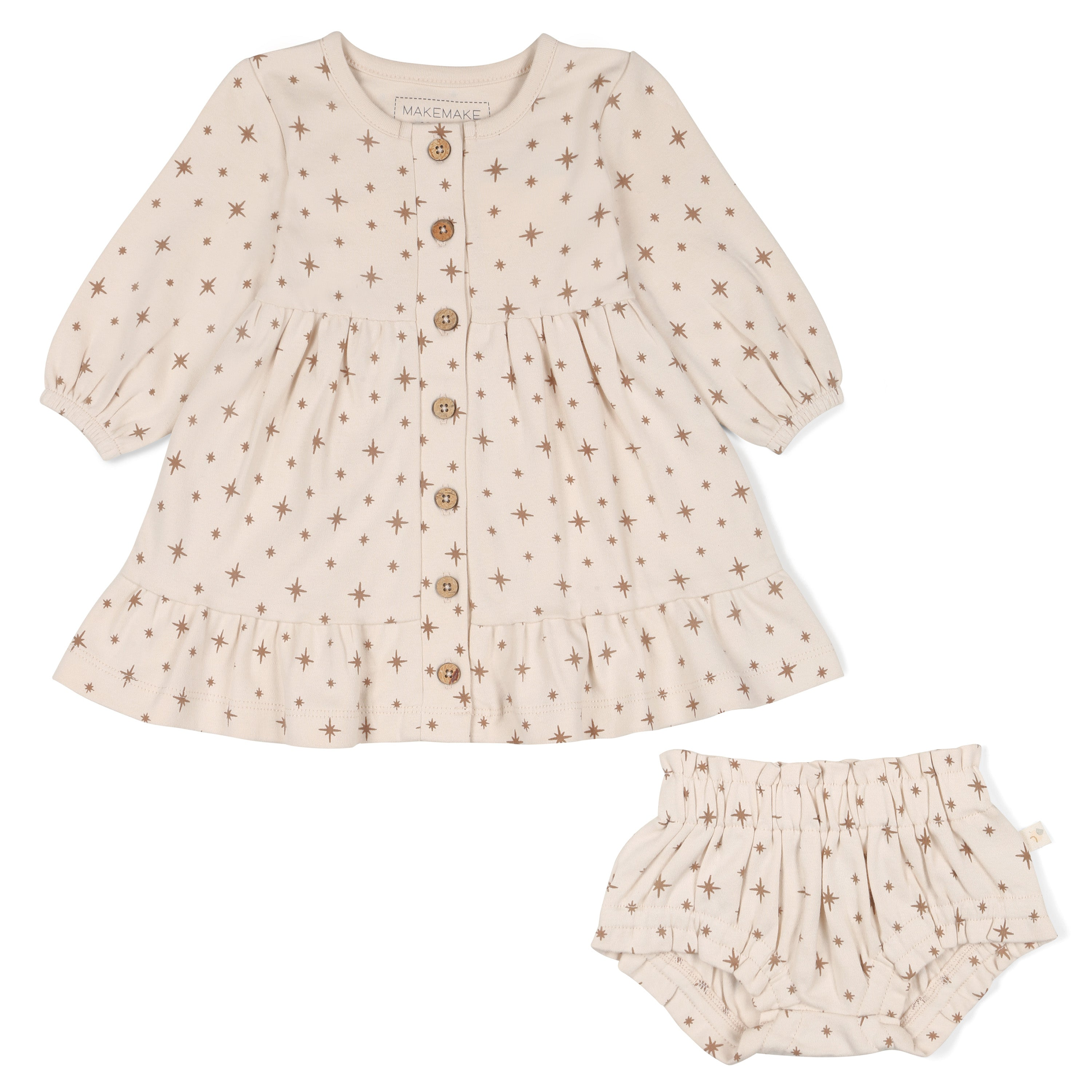 A beige baby dress with star patterns and button details, paired with matching bloomers.