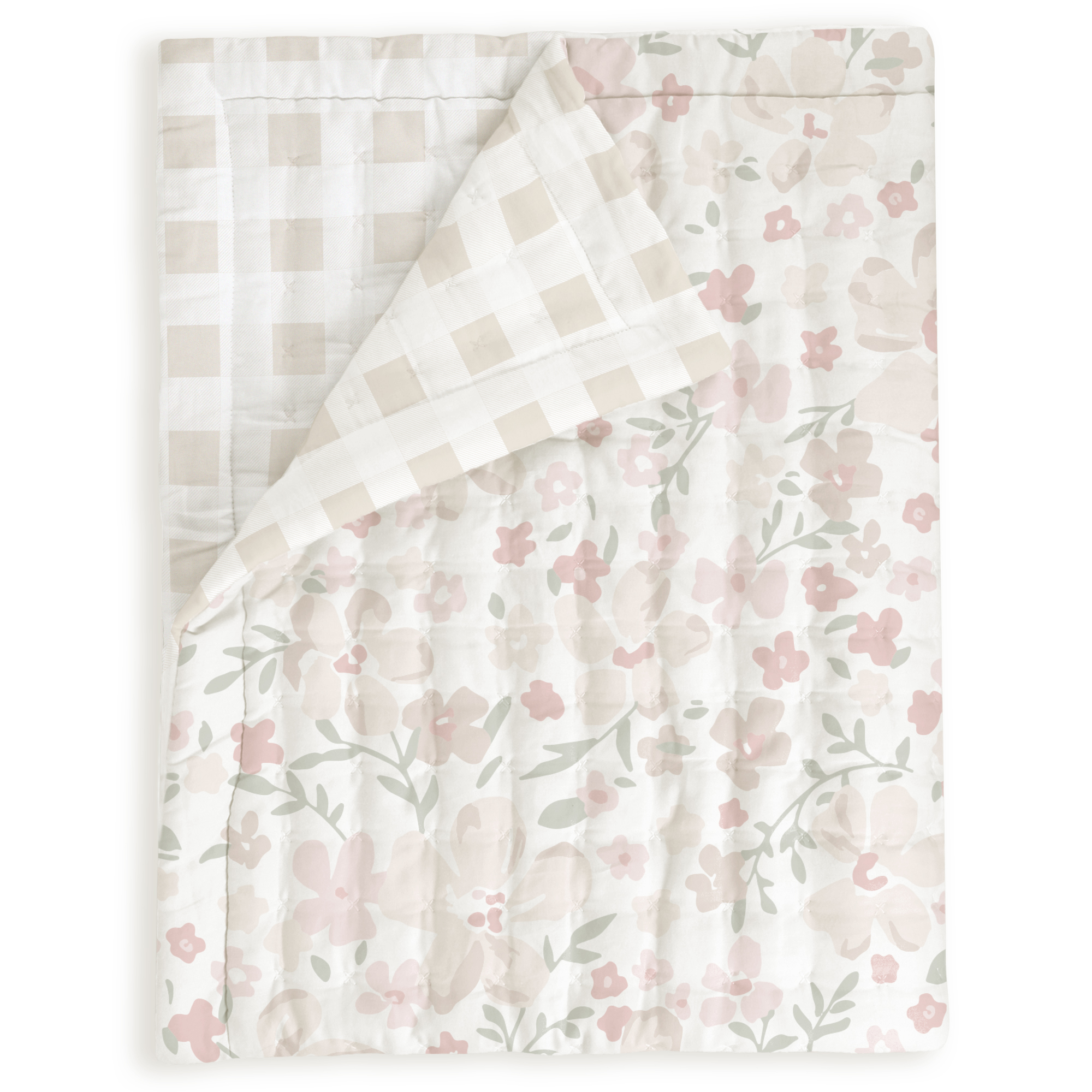 A neatly folded Organic Cotton Comforter - Blossom & Plaid from Makemake Organics featuring a floral pattern with pink flowers and green leaves on a white background, partially covered by a plaid throw blanket in muted tones.