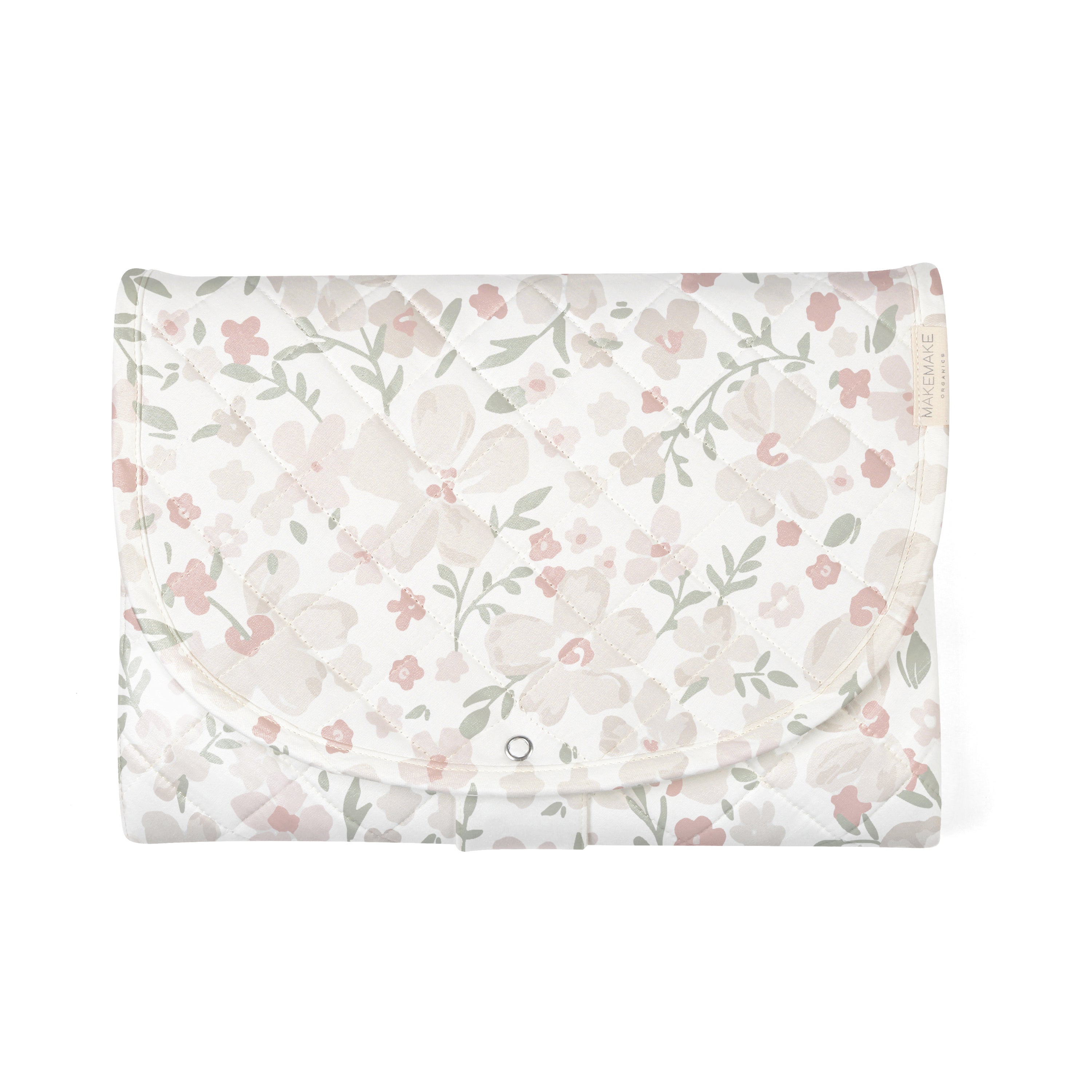 A floral patterned Organic Cotton Portable Changing Mat - Blossom from Makemake Organics with soft tones of pink and green, featuring detailed blossoms and leaves, laid flat on a white background.