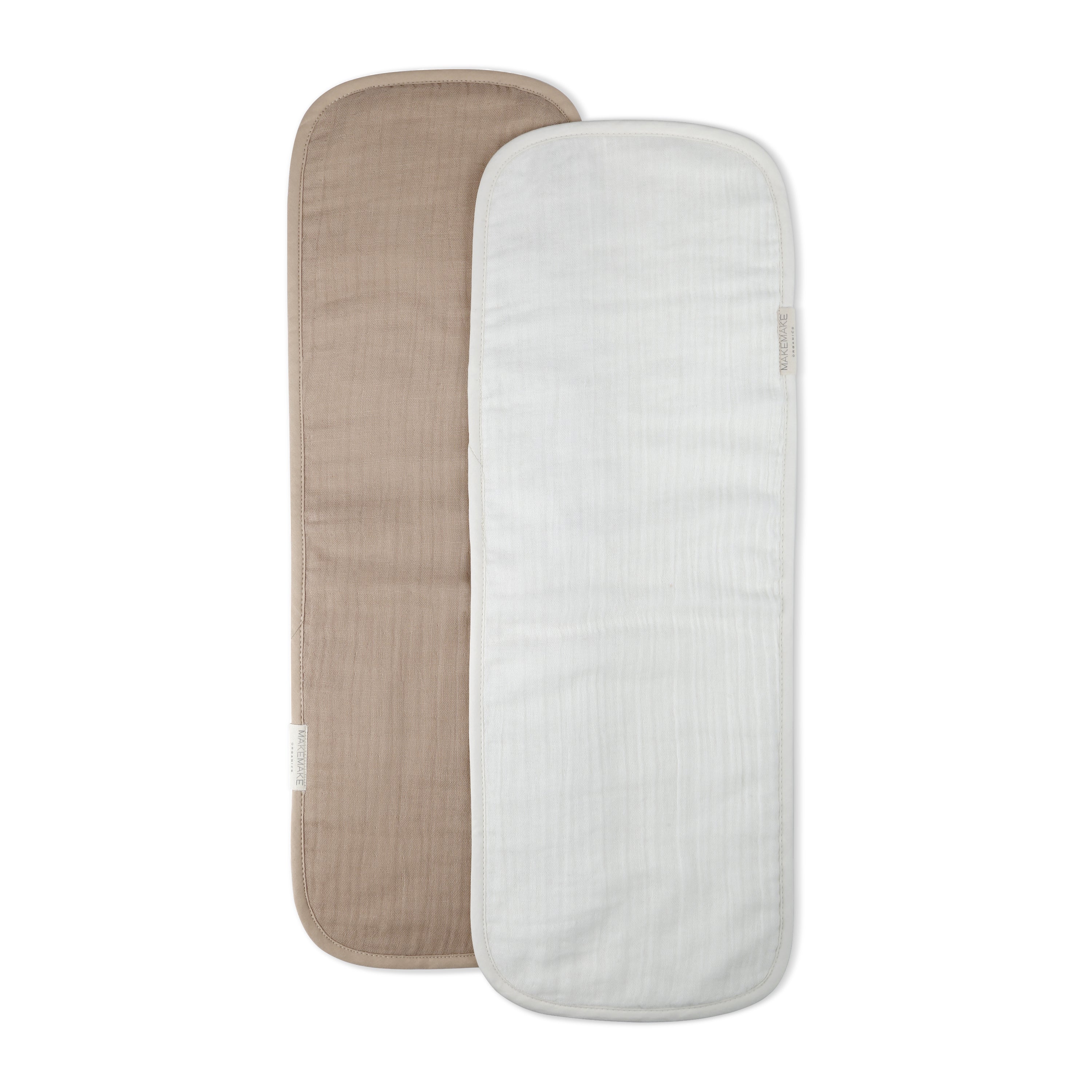 Two Organic Cotton Muslin Burp Cloths in Ivory & Taupe on a white background, one in beige and the other in white, both with visible tags on the side. Brand: Makemake Organics.
