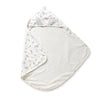 A white Organic Cotton Hooded Baby Towel & Poncho - Bloom by Makemake Organics laid flat, with one side featuring a floral pattern and the other side plain, shaped like a quarter circle with a hood at the curved side.