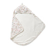 A Makemake Organics Organic Cotton Hooded Baby Towel & Poncho - Blossom with a floral pattern on one side and a white, soft texture on the inside, laid flat on a white background.