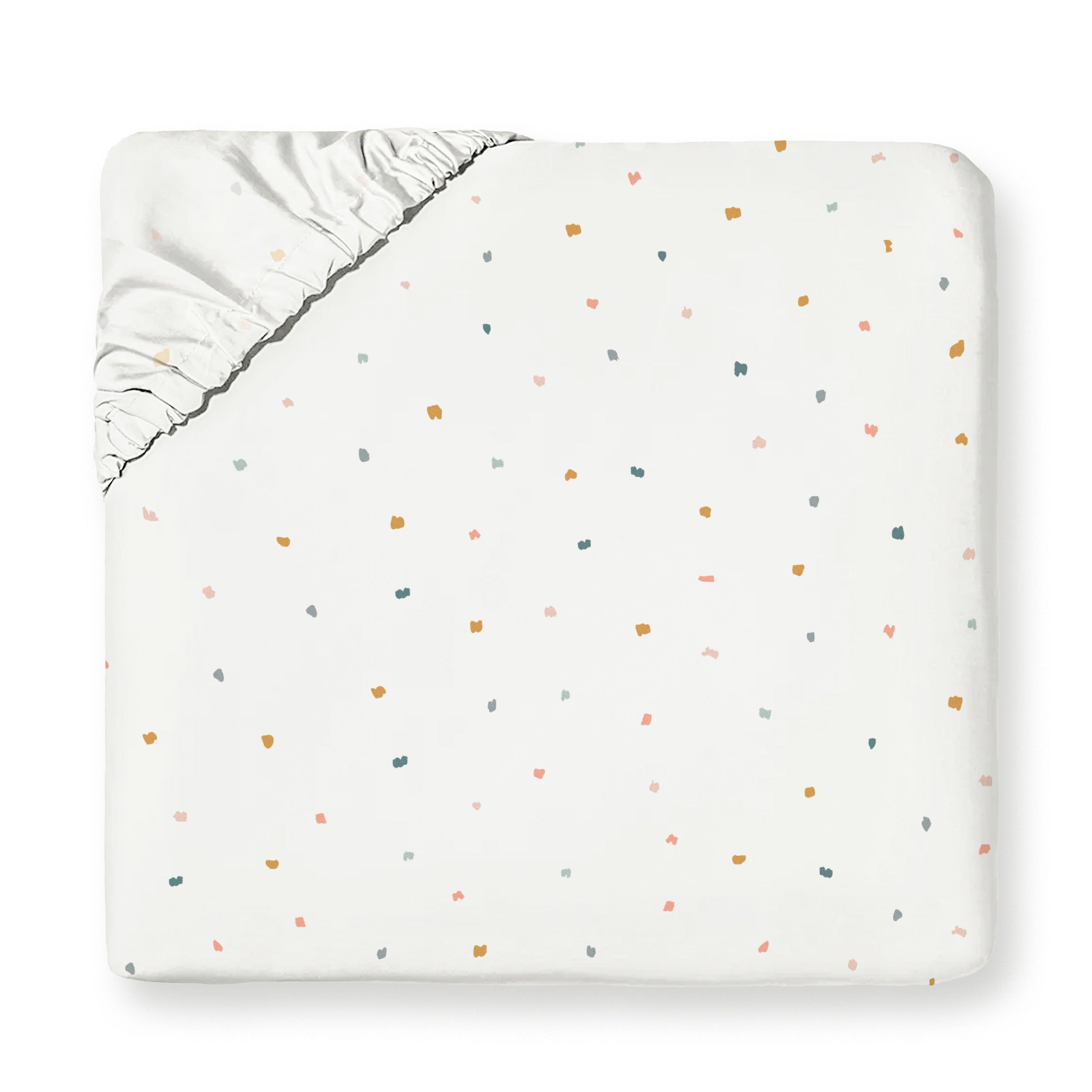 A baby blanket with a white background featuring a multicolored confetti pattern and a silver satin trim, neatly folded into a square shape is the Organic Cotton Fitted Sheet Set - Dotty by Makemake Organics.