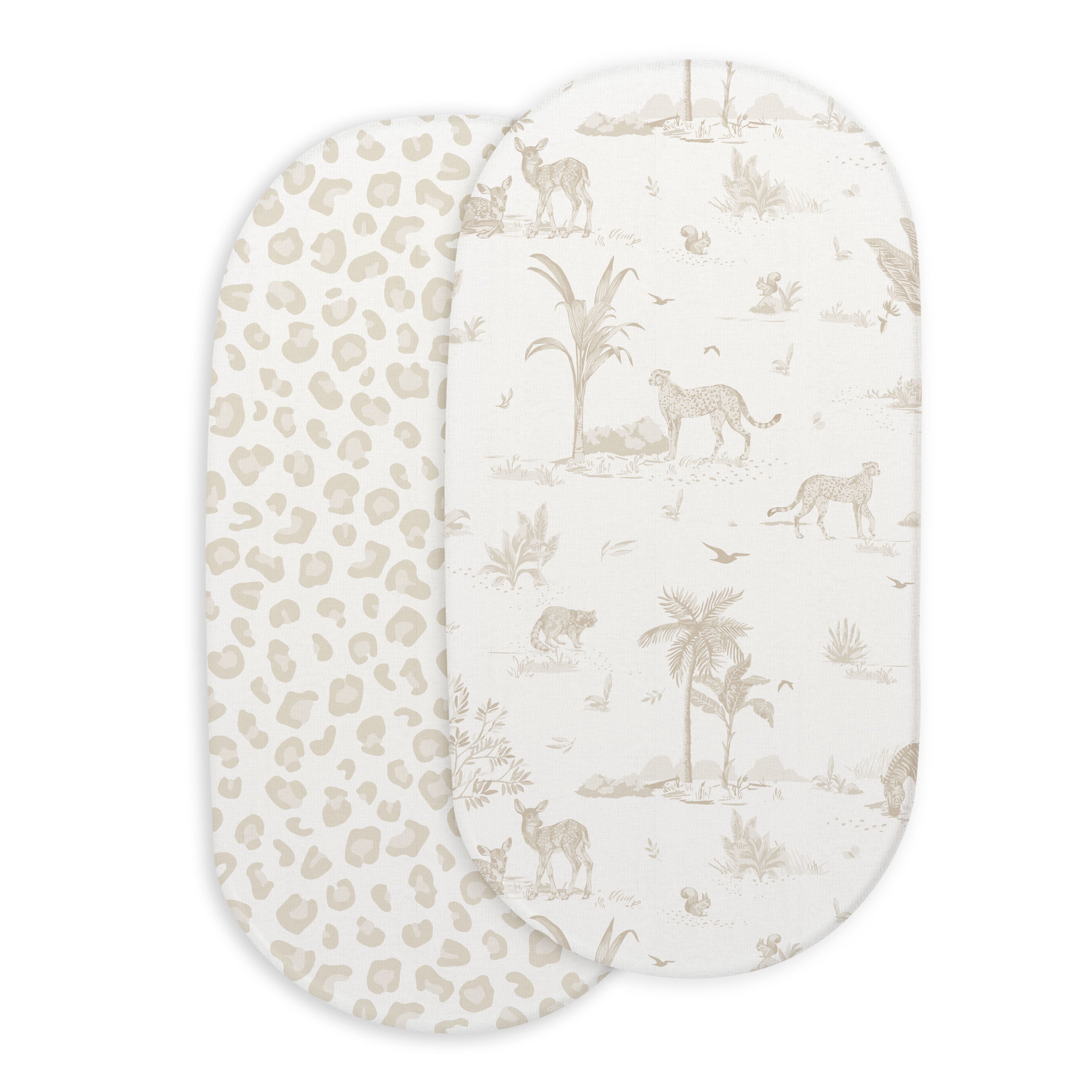 Two oval-shaped Makemake Organics bassinet mattresses with Safari & Wild fitted sheets; one features an animal print with leopards and trees, the other has a simplistic beige and white leopard spot pattern.