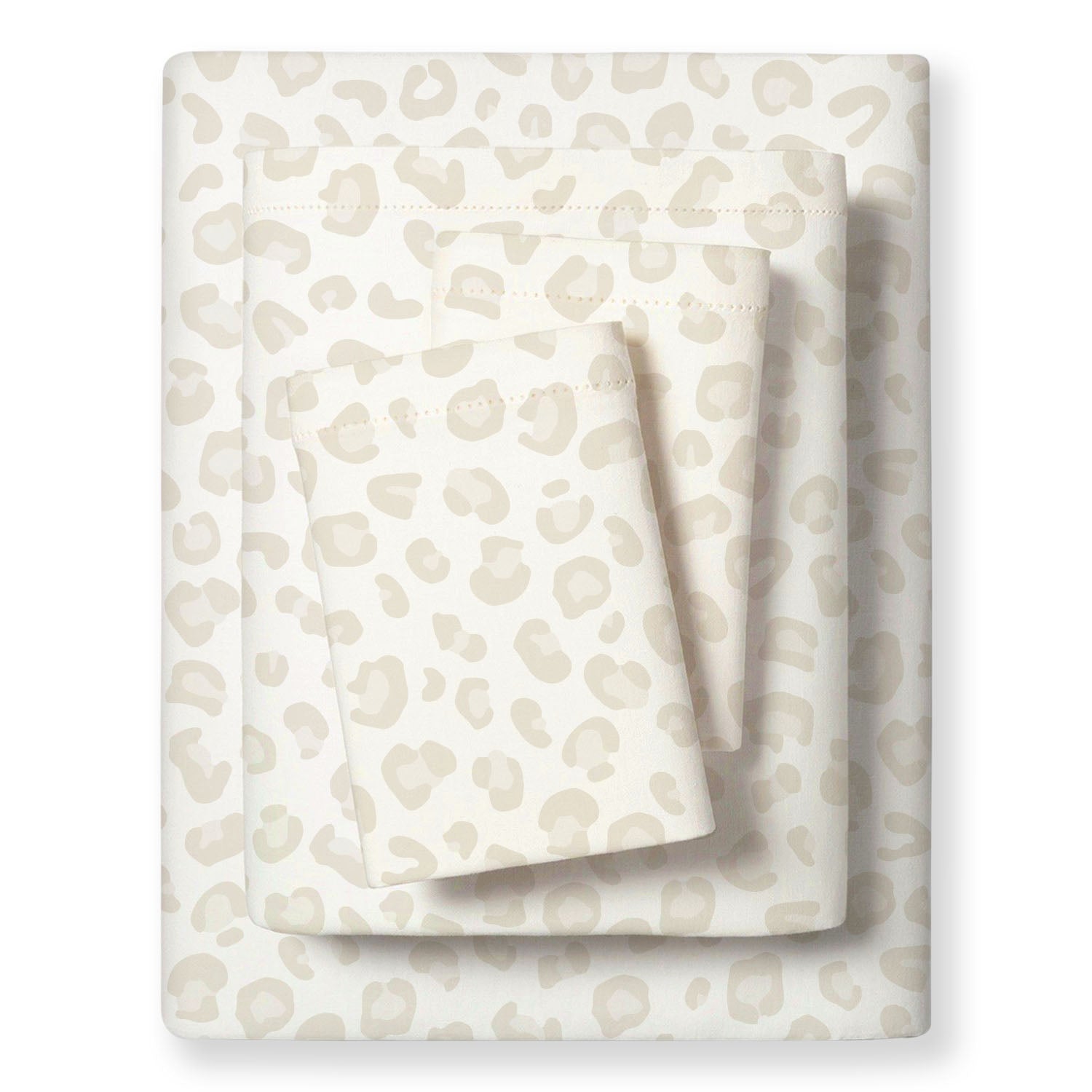 A neatly folded set of Organic Cotton Sheet Set in Wild Cream from Makemake Organics, with a subtle, abstract print, displayed on a plain white background.