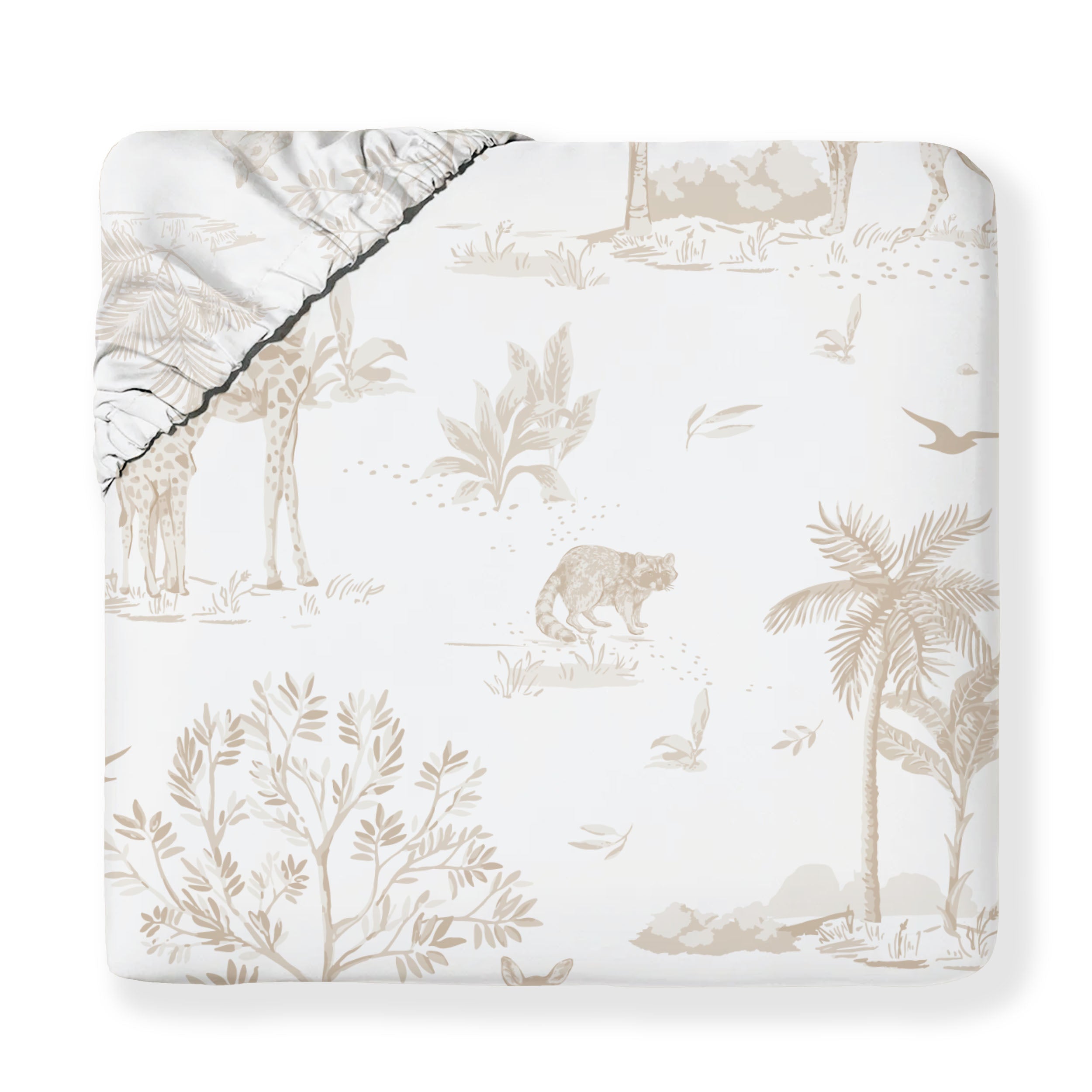 A beige Organic Cotton Fitted Sheet Set - Safari from Makemake Organics, featuring a jungle-themed pattern with depictions of palm trees, various plants, and animals like bears and birds, partially folded to show the white underside.