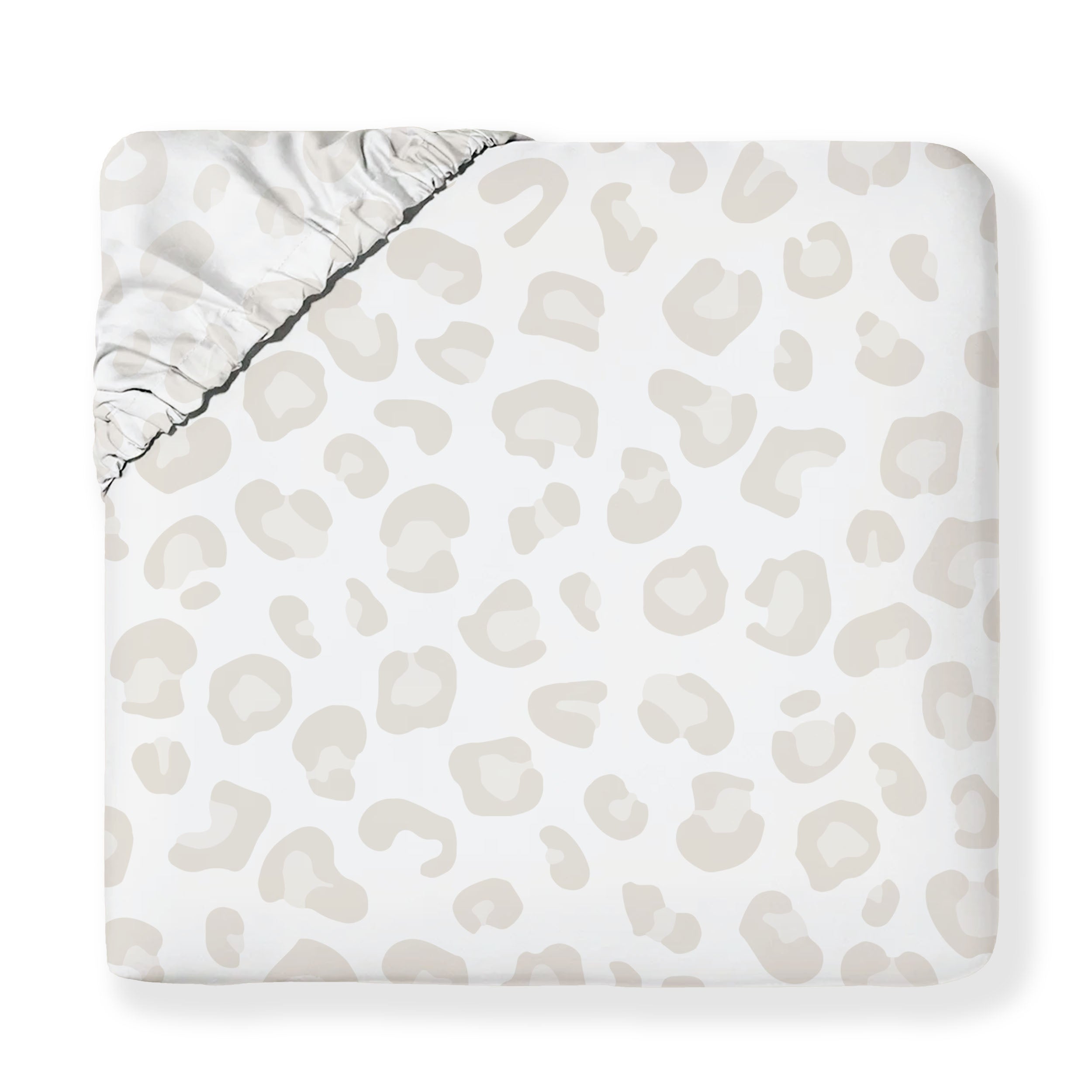 A Wild Organic Cotton Fitted Sheet Set by Makemake Organics with a beige and white abstract leopard print design, displayed flat with a visible elastic corner.