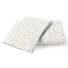 A pair of folded Wild leopard print towels in neutral colors on a white background.