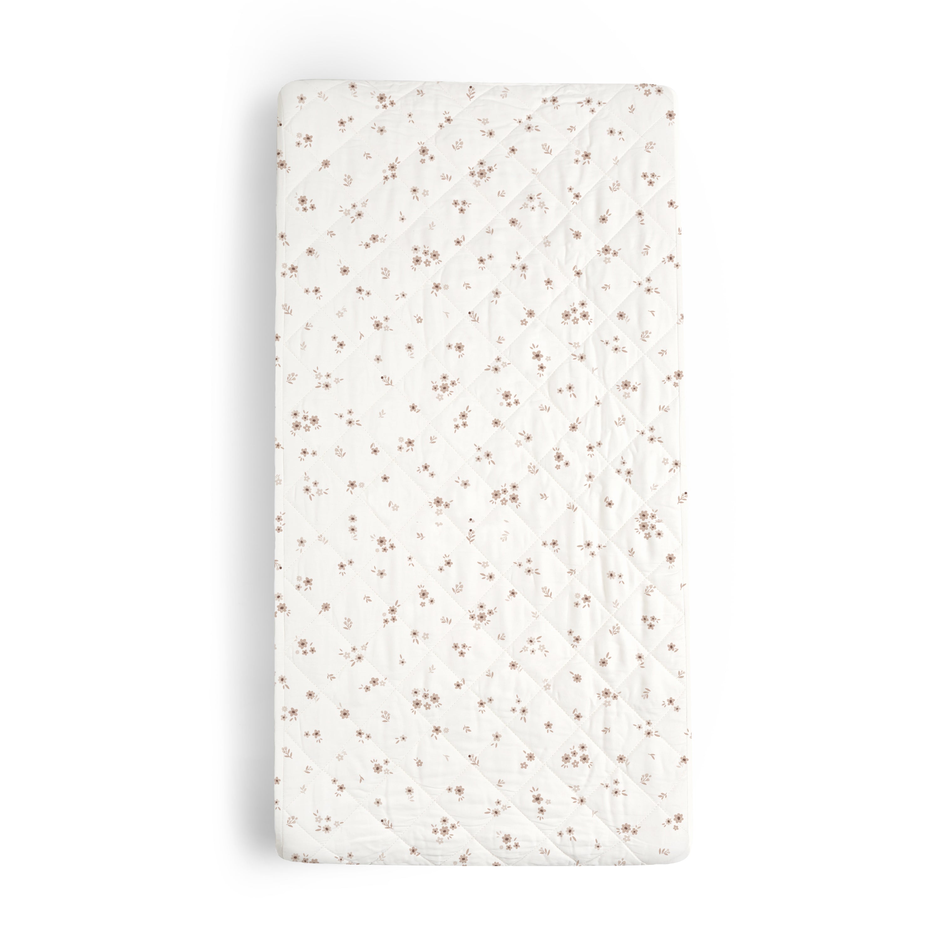 A top-down view of an Organic Cotton Changing Pad Cover - Bloom by Makemake Organics isolated on a white background. The cover displays a quilted design with small, delicate flowers.