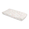 A Makemake Organics Organic Cotton Changing Pad Cover - Blossom, with a soft floral pattern in shades of pink and white, placed against a clean, white background.