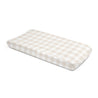 A beige and white checkered Organic Cotton Changing Pad Cover - Plaid by Makemake Organics isolated on a white background.