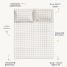 An image displays a plush, 300-thread count sateen bedding set from Makemake Organics, including two pillowcases, described as gots certified, organic, ultra-soft, breathable, and featuring a snug, secure elastic fit. the design is a subtle, pale checkered pattern.