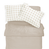 Top view of a neatly made bed with a taupe duvet and two pillows in white and beige gingham covers, including the Organic Cotton Toddler Pillowcase - Plaid from Makemake Organics.