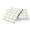 Two folded Makemake Organics Organic Cotton Toddler Pillowcase - Plaid napkins on a white background.