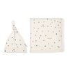 Two cream-colored cosmetic bags with black polka dots; one bag is a pouch with a knotted tie and the other is a flat square shape with a zipper, both featuring a "Makemake Organics" logo.