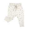 A pair of baby-sized Organic Harem Pants - Pixie Dots in a cream color, decorated with black polka dots, featuring cuffed ankles and a drawstring waist, displayed on a white background by Makemake Organics.