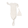 A white toddler sleeper with a knotted bottom and black speckles, paired with a matching beanie, laid flat on a white background. Organic Kimono Knotted Sleep Gown - Pixie Dots by Makemake Organics.