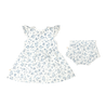A toddler's Organic Muslin Button Flutter Dress in Periwinkle by Makemake Organics with a matching pair of bloomers laid out flat on a white background. The dress features short, ruffled sleeves and a flared skirt.