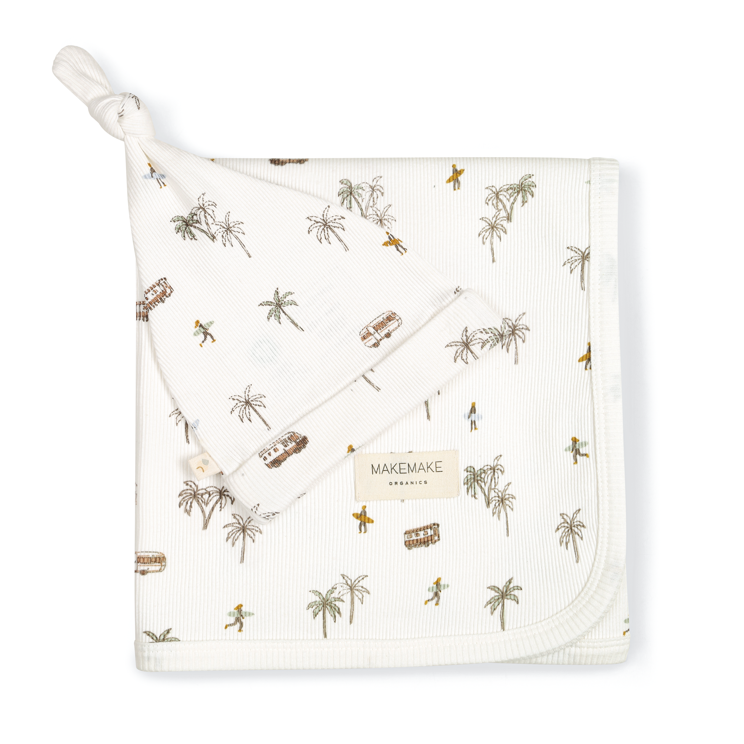 White Organic Swaddle Blanket & Hat - Malibu by Makemake Organics, with tropical-themed patterns, including palm trees and surfboards, neatly folded with a corner tied in a knot, displayed against a plain background.