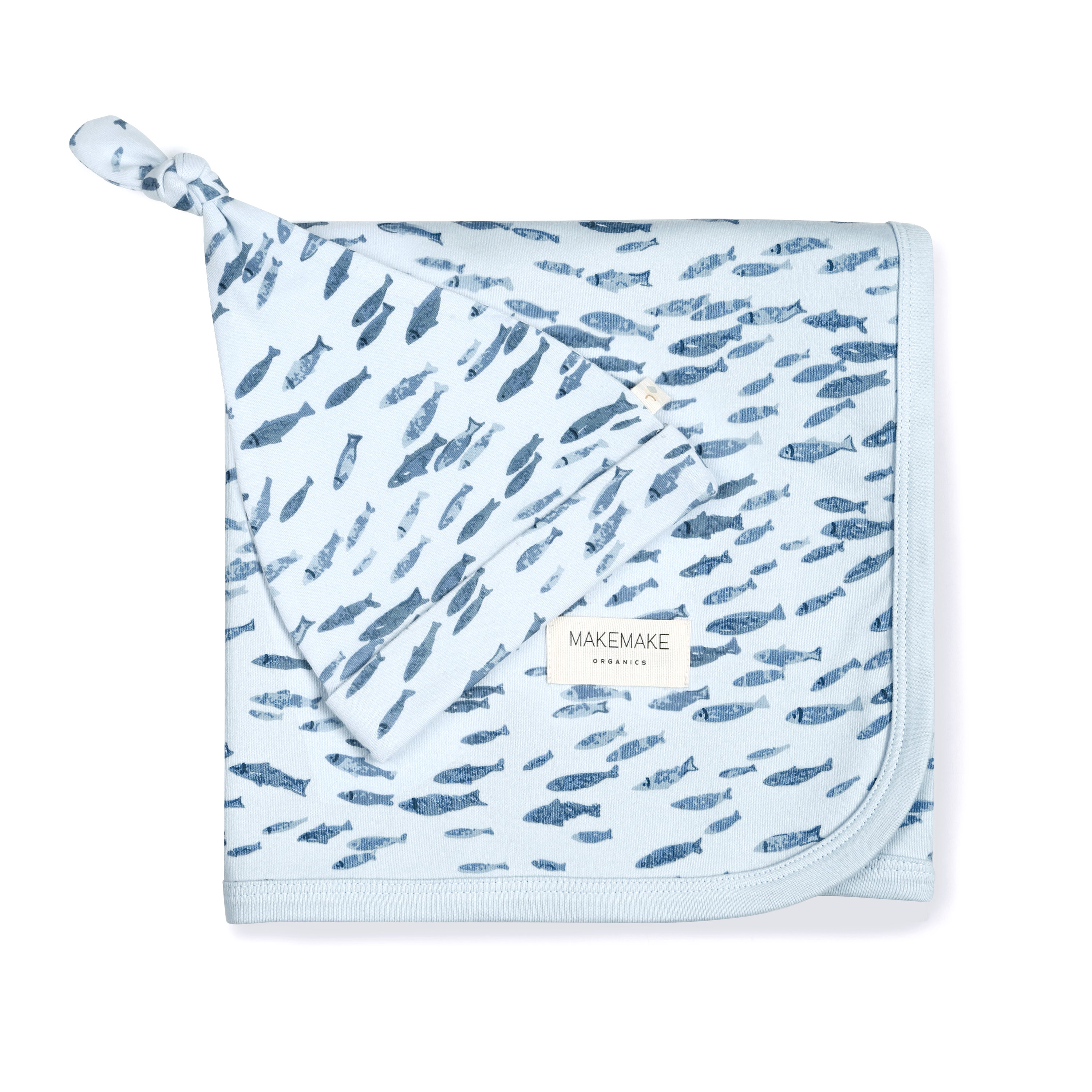A light blue Organic Swaddle Blanket & Hat with a pattern of small gray feather prints, folded neatly on a white background, featuring a visible brand tag that reads "Makemake Organics.