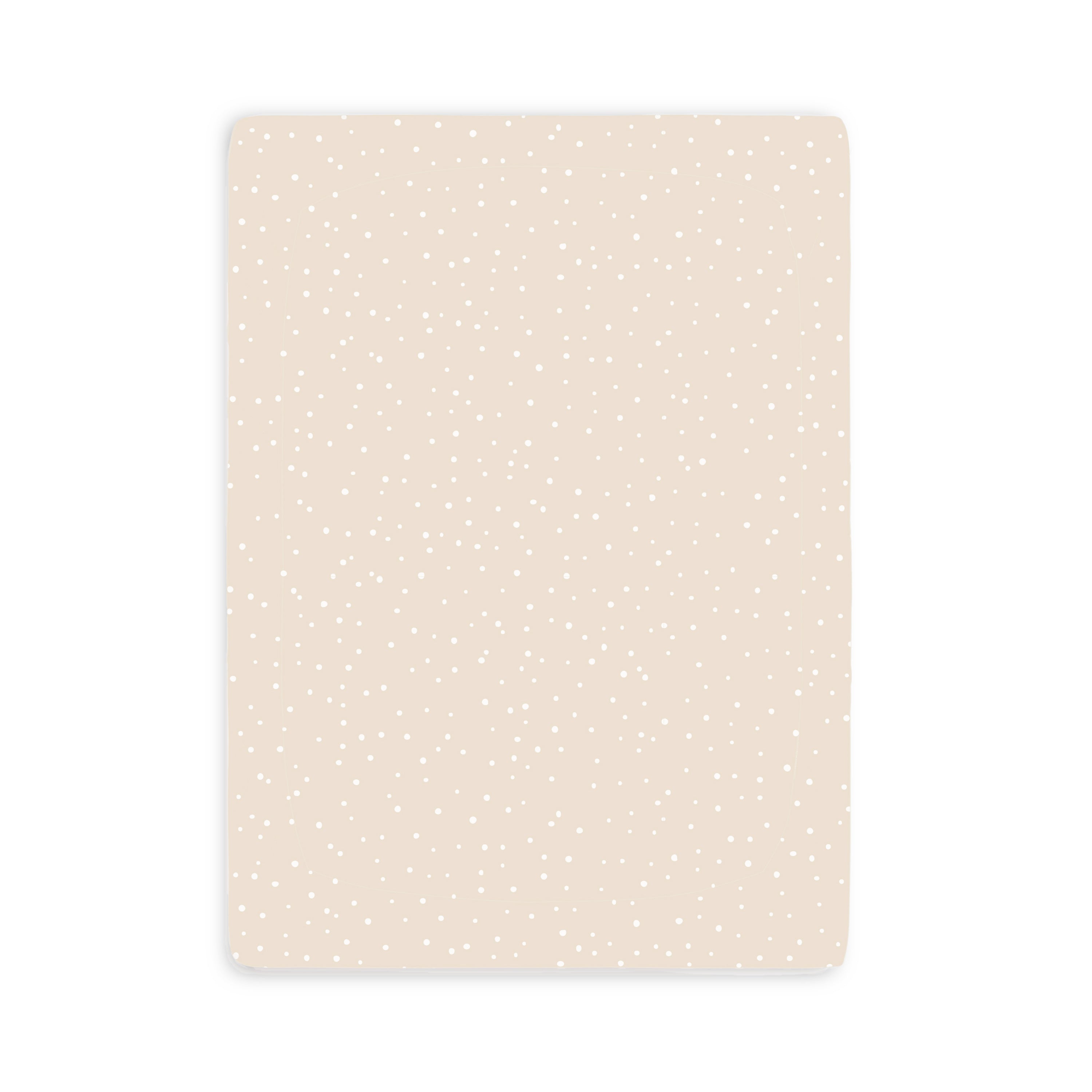 A simple rectangular card with a pale peach background dotted with small white spots, resembling a subtle polka dot pattern from Makemake Organics' Mini Crib Fitted Sheet - Polka Dots.
