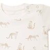 Close-up of a baby bodysuit featuring a pattern of cheetahs in various poses, crafted in a neutral color palette with a label at the neckline reading "Organic Kids - Wildcat Print".