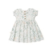 A toddler's Organic Puff Sleeve Dress - Wild Safari from Organic Kids, with a botanical print, featuring a gathered waist and wooden buttons down the front, displayed on a white background.