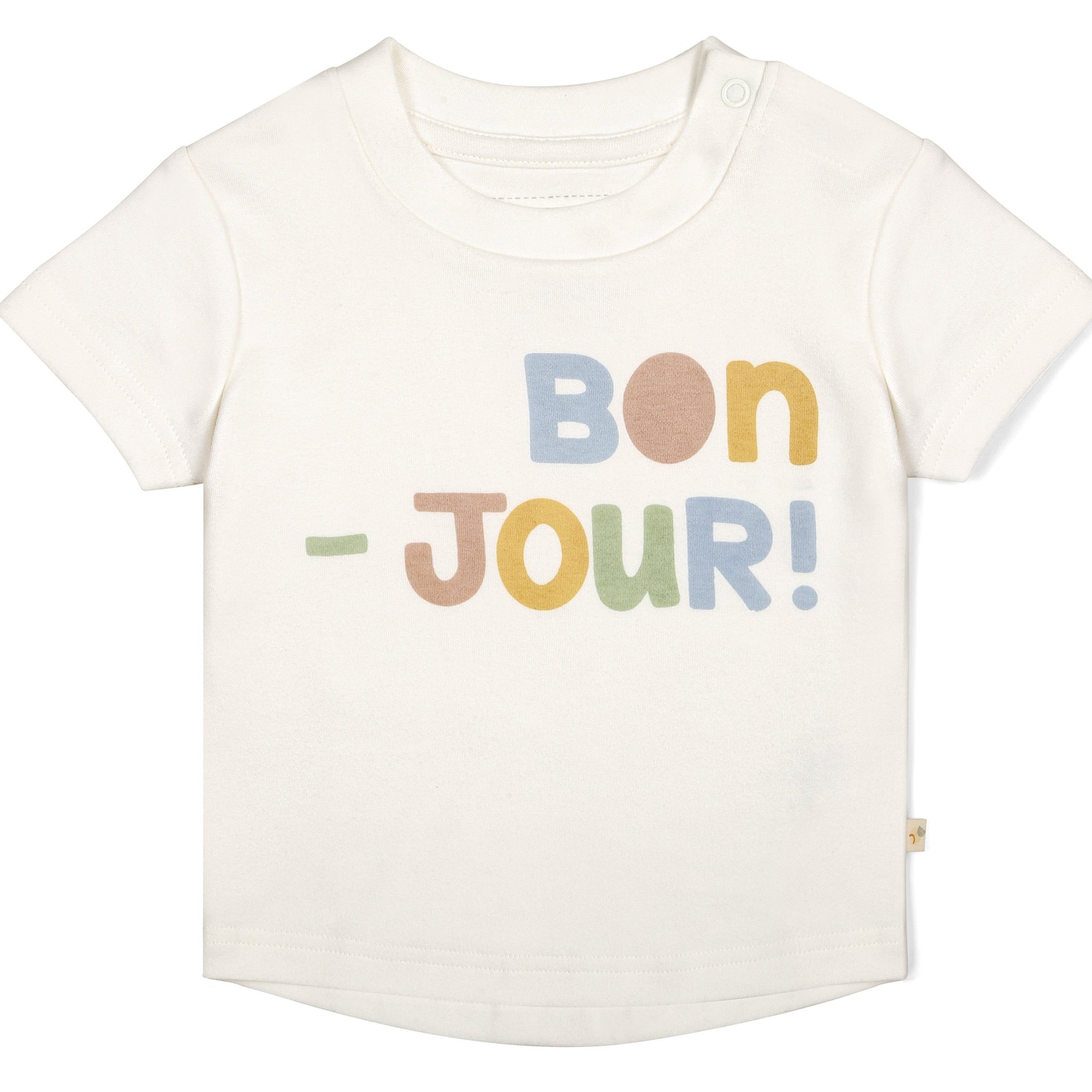 Toddler Makemake Organics organic crew neck tee in white with colorful text "bon-jour!" in rainbow font, featuring a side snap at the shoulder.