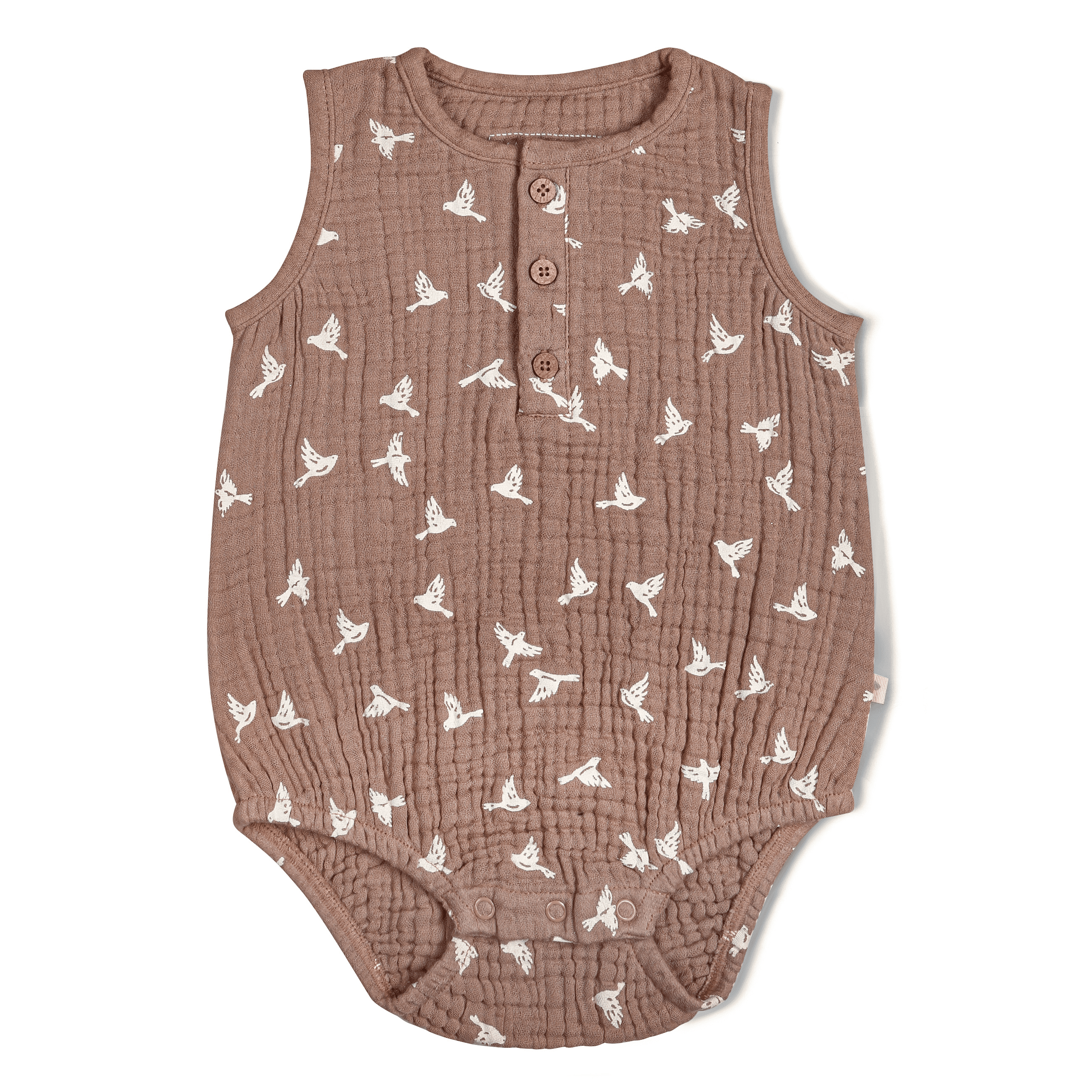 A sleeveless textured toddler romper in light brown color, featuring an all-over white bird print, laid flat on a white background.