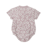 A toddler Organic Bubble Romper - Daisies by Makemake Organics with short sleeves, decorated with a pattern of white flowers on a light purple background, displayed flat against a white surface.