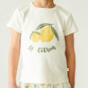 Toddler wearing a Makemake Organics Organic Crew Neck Tee - Le Citron with a yellow lemon graphic and the text "le citron" in green. Only the torso is visible, against a plain background.