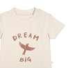 Close-up of a beige Makemake Organics Organic Crew Neck Tee - Dream Big toddler t-shirt with the phrase "dream big" and a silhouette of a bird in a darker shade, located centrally on the chest. The t-shirt has a round neckline.