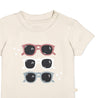 A beige toddler's Organic Crew Neck Tee - Shades by Makemake Organics with a graphic of three pairs of sunglasses in pink, white, and blue, decorated with stars, displayed on a plain background.