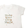A white Organic Tee & Pants Set from Organic Kids with the phrase "make your own magic" printed in colorful, stylized letters, displayed on a plain white background.