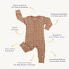 Flat lay image of a brown Organic Buttoned Romper - Sparkle from Organic Baby, featuring a button neckline and white star pattern, with details like extra diaper room, convertible footies, and highlighted as GOTS certified. Suitable for sizes up to 12m.