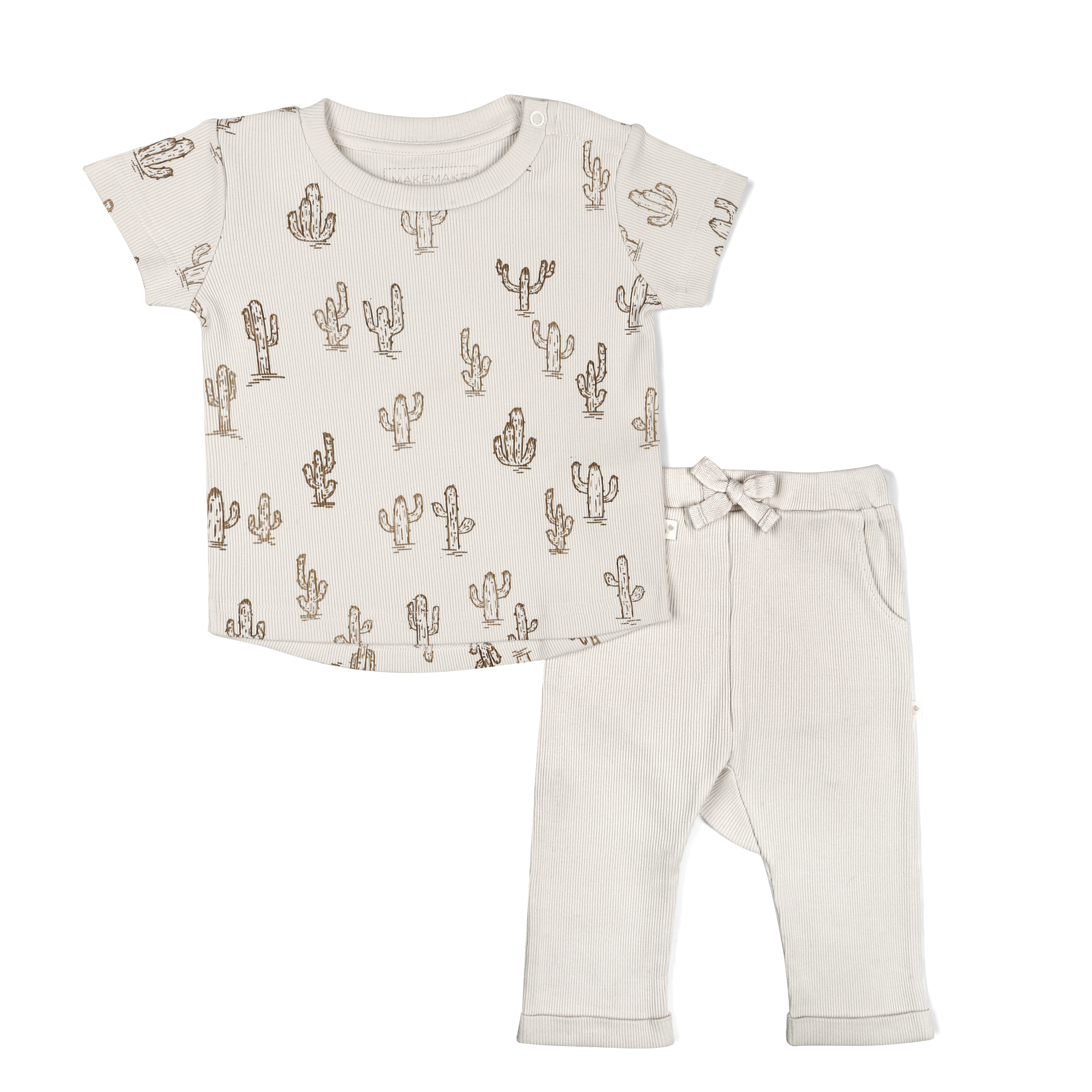 A Makemake Organics baby outfit consisting of a beige short-sleeved shirt with a cactus print and coordinating beige leggings with a bow at the waist, displayed against a white background.