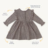 A gray Organic Ruffle Dress - Speckle with long sleeves, decorated with small white dots from Organic Girls, displayed on a white background. Features highlighted include snap buttons, stretchiness, softness, breathability