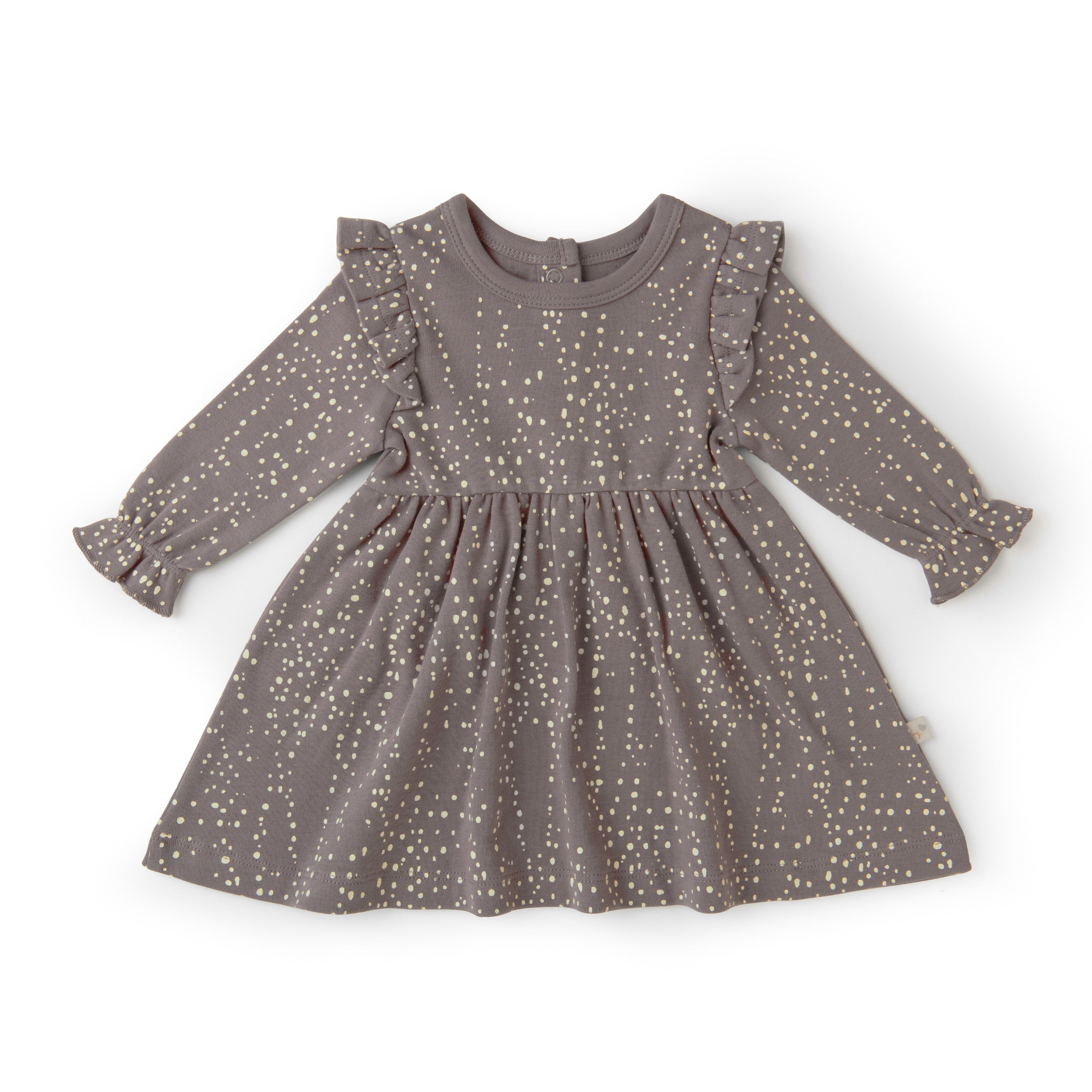 An Organic Girls gray toddler dress with long sleeves, adorned with small, gold polka dots, featuring ruffle details on the shoulders, displayed on a plain white background.