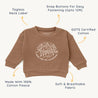 A brown cotton fleece toddler sweatshirt from Organic Baby with the words "adventure" and "made for the mountains" printed on the front. Features include a tagless neck label.