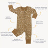 Image of a baby's Organic 2-Way Zip Romper - Wildflower, beige with floral patterns, highlighting features like a 2-way zipper, foldover mitts, extra diaper room, and fabric neck protector. tagged as gots certified and ultra-soft for babies up to 12 months by Organic Baby.