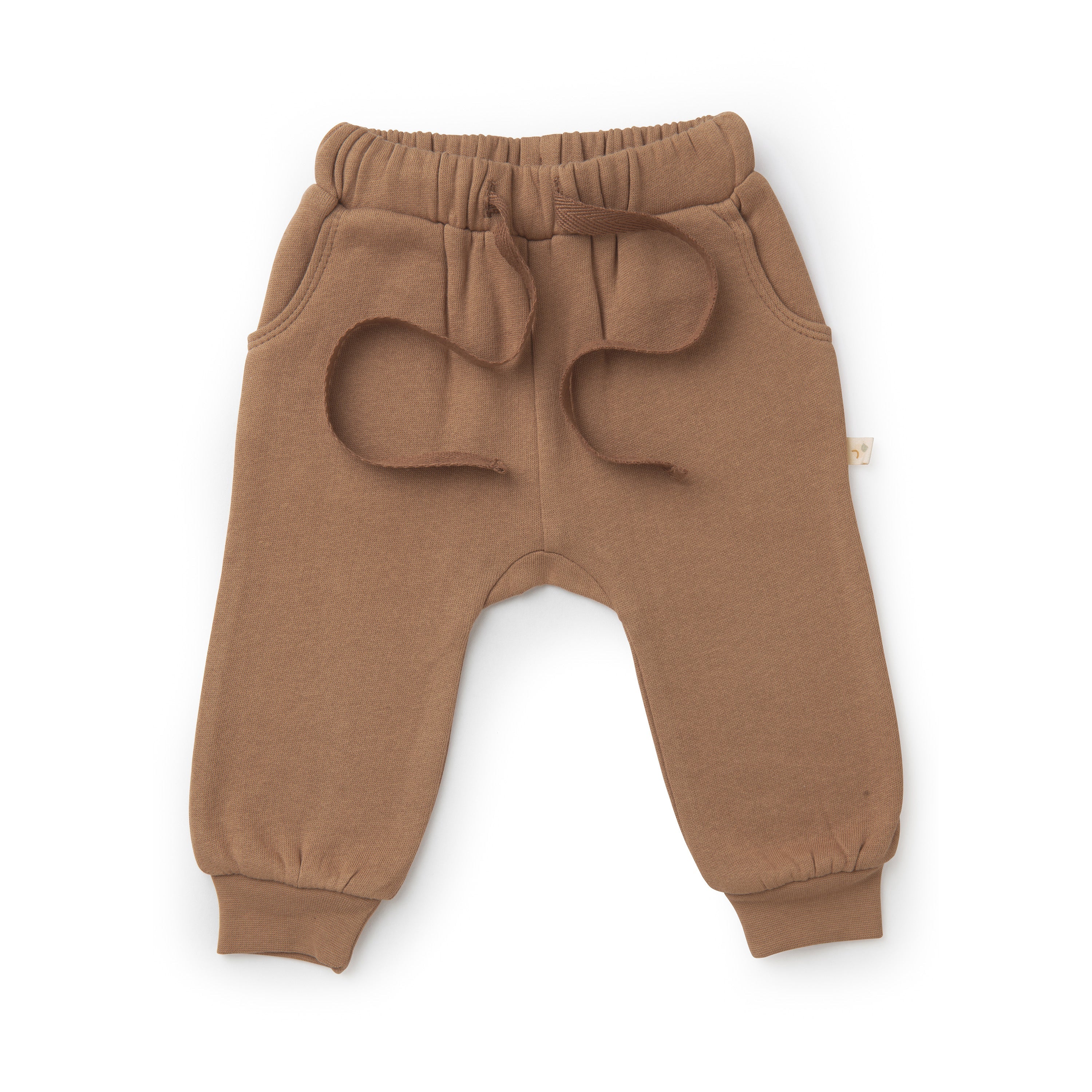 A pair of Organic Baby toddler's brown jogger pants in cocoa with an elastic waistband and ribbed cuffs, featuring round patch pockets on the front. The garment is displayed isolated on a white background.